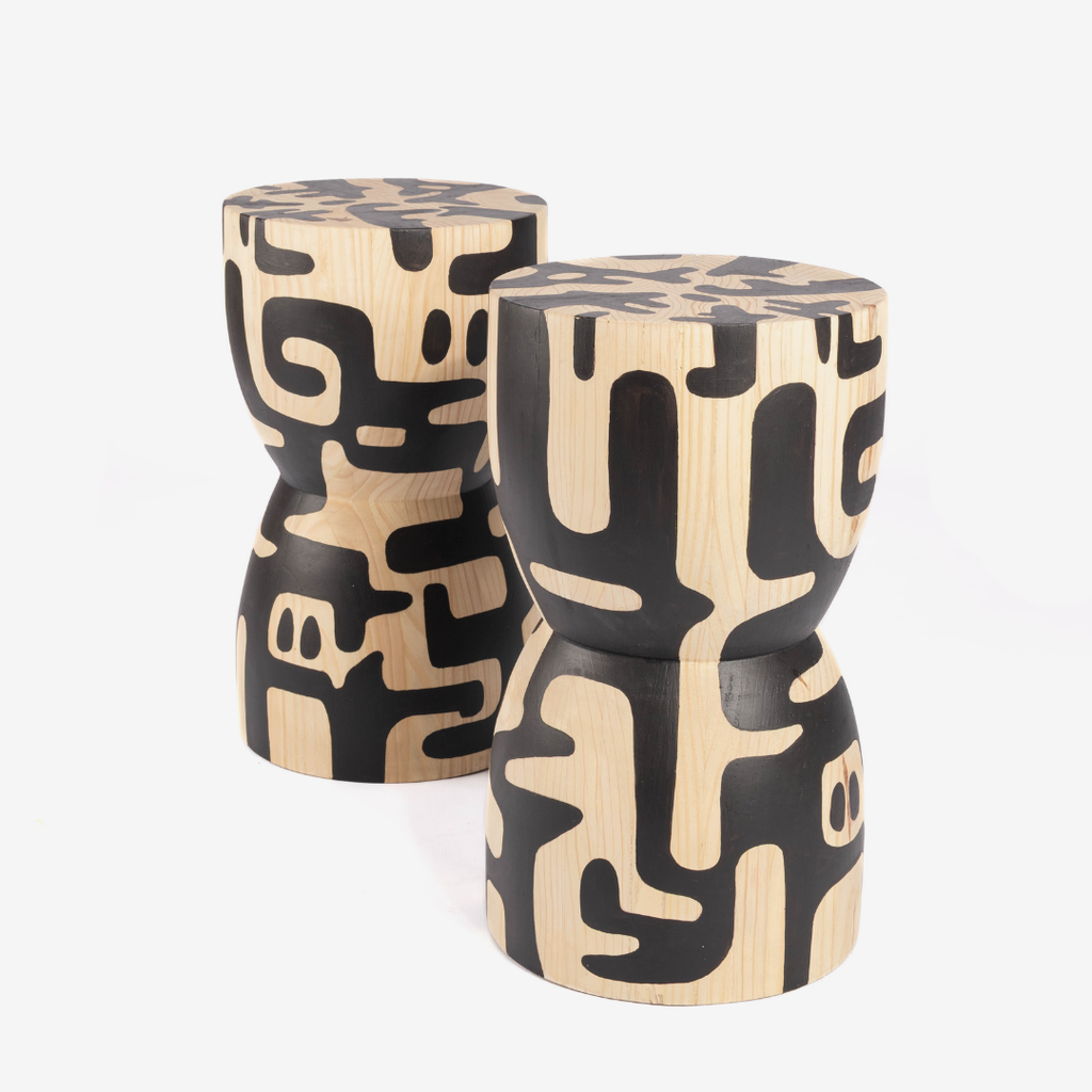 Two wooden stools with black abstract patterns on a white background