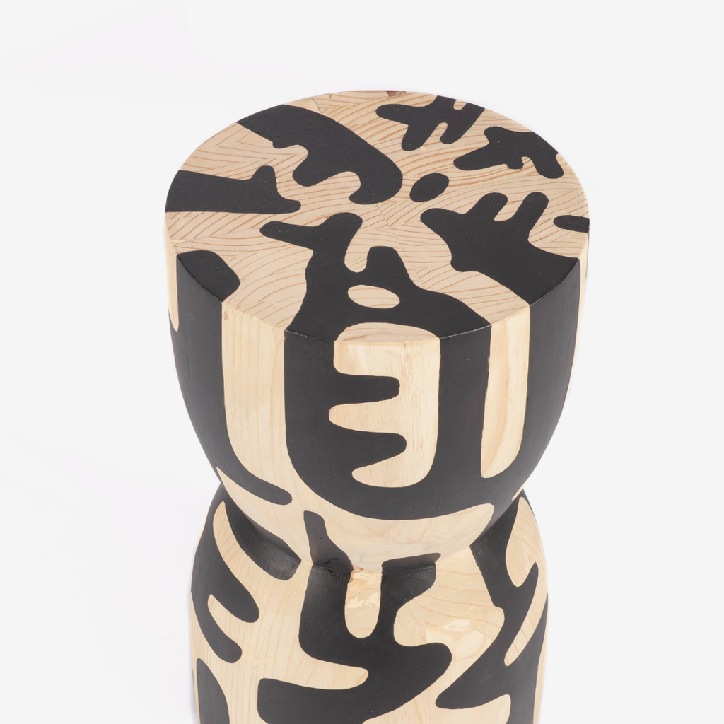 Wooden stool with black abstract patterns on a white background