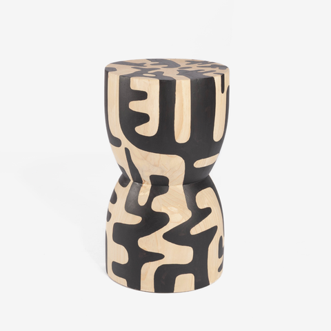Decorative stool with black and beige abstract pattern on a white background