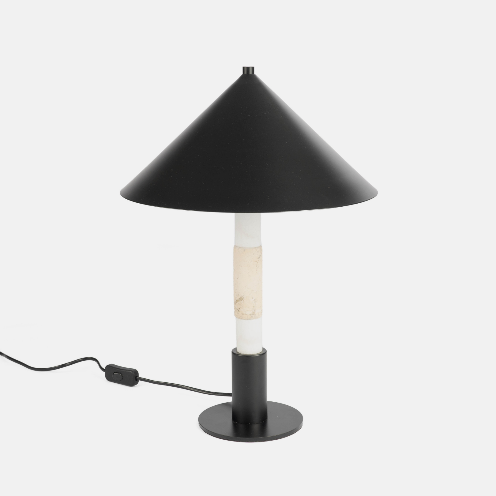 A steel and marble table lamp on a light grey background 