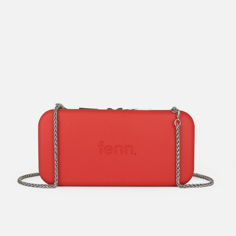 Red handbag with 'fenn' branding on a white background